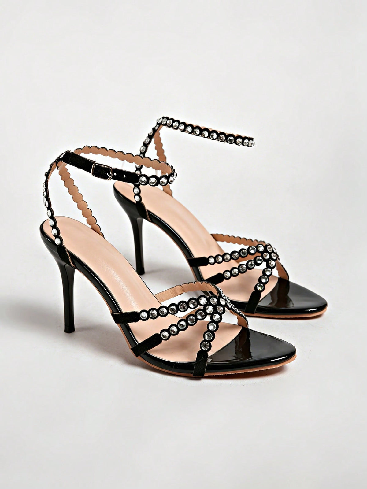 Women's open toe stiletto high heel sandals featuring metallic knot decor and an adjustable ankle buckle strap.