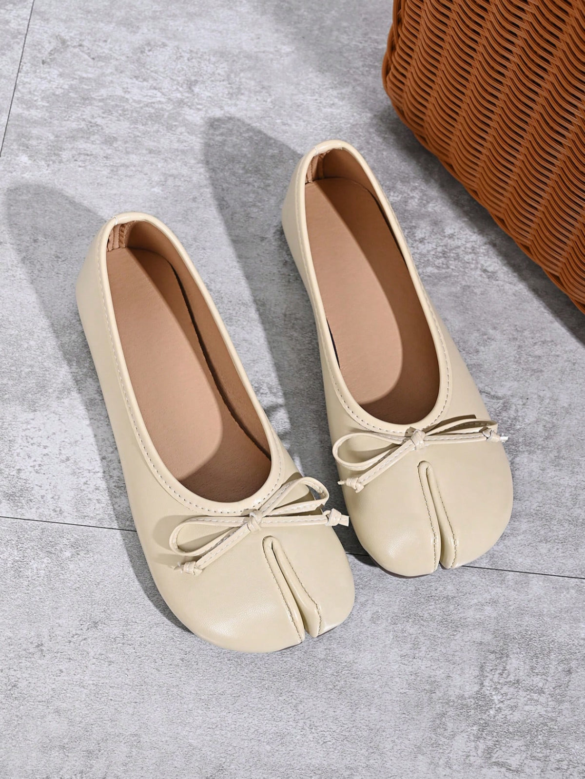 Women's white split-toe slip-on flat shoes with braided accent and rubber sole