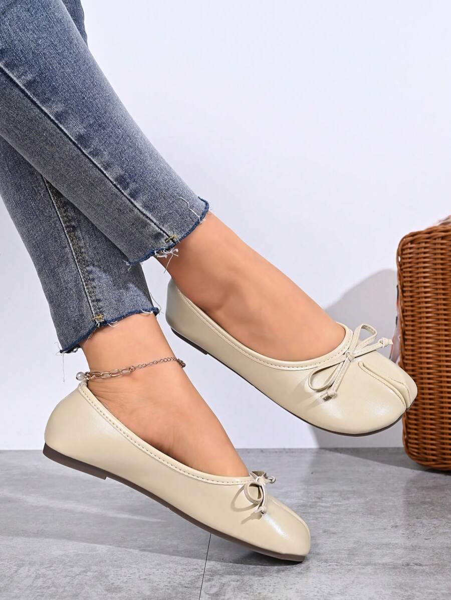 Women's white split-toe slip-on flat shoes with braided accent and rubber sole