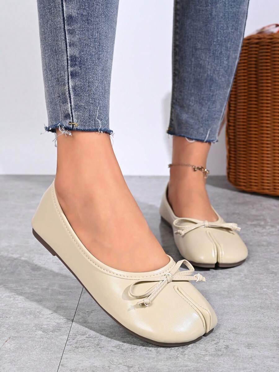Women's white split-toe slip-on flat shoes with braided accent and rubber sole