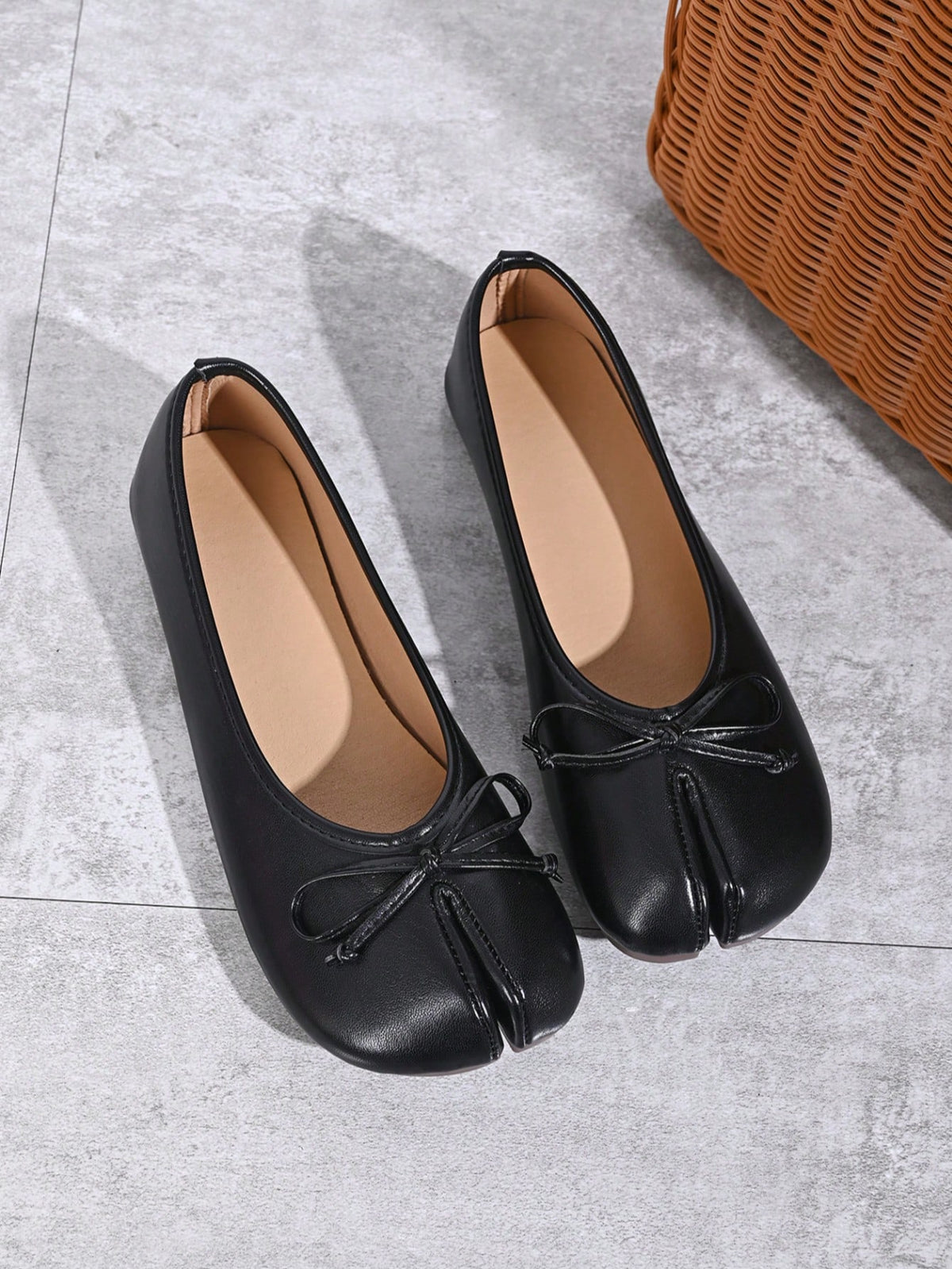 Women's white split-toe slip-on flat shoes with braided accent and rubber sole