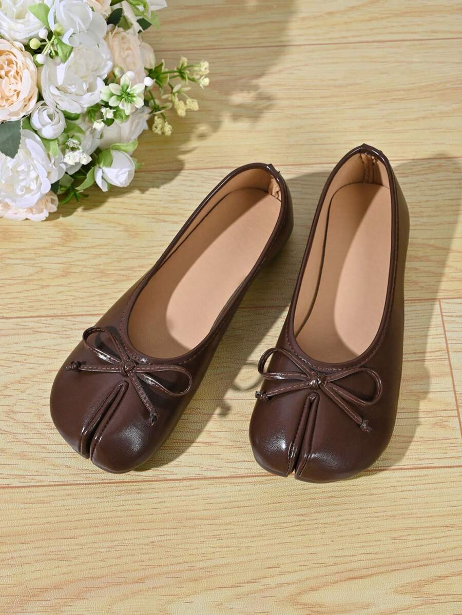 Women's white split-toe slip-on flat shoes with braided accent and rubber sole