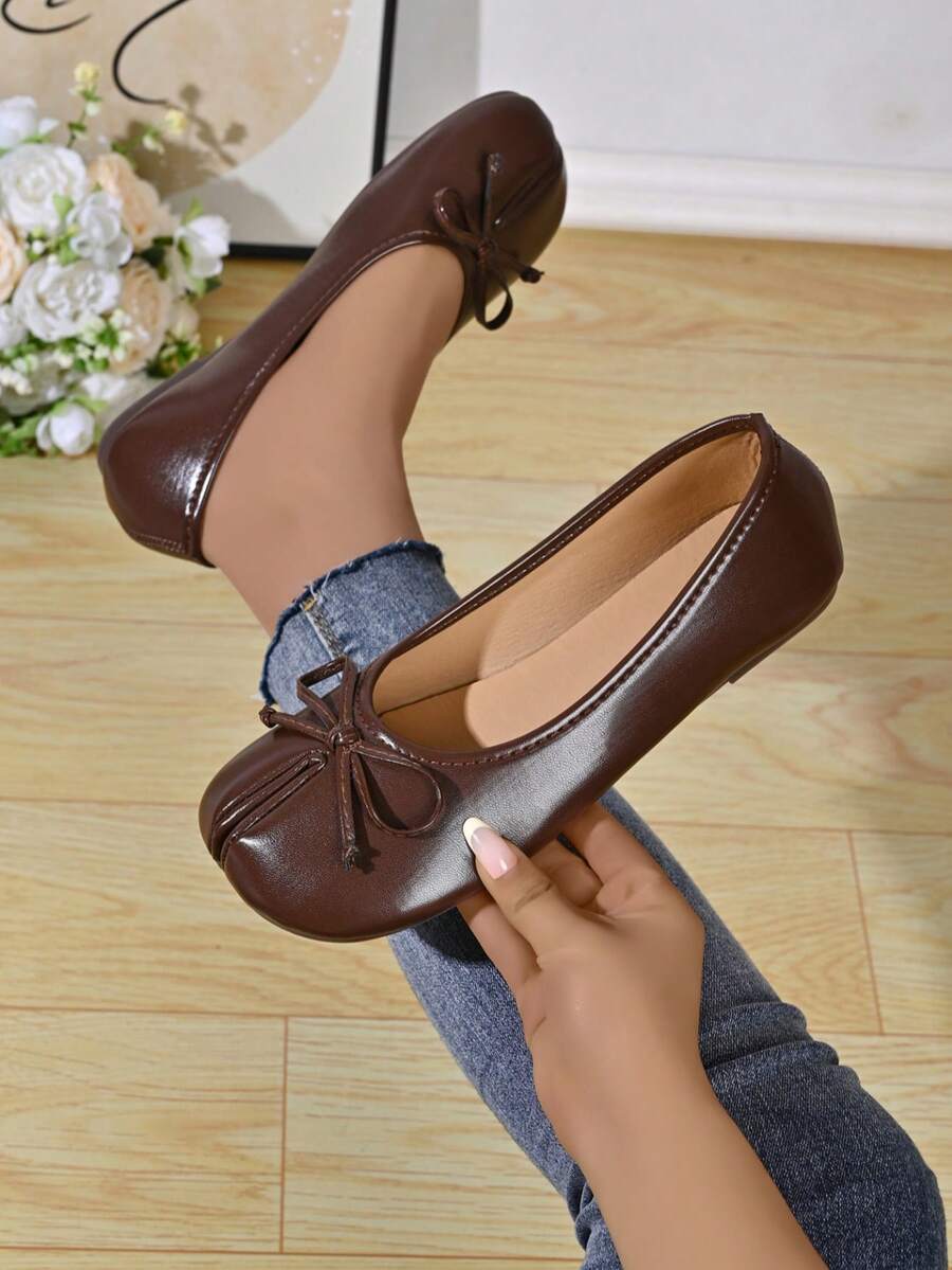 Women's white split-toe slip-on flat shoes with braided accent and rubber sole