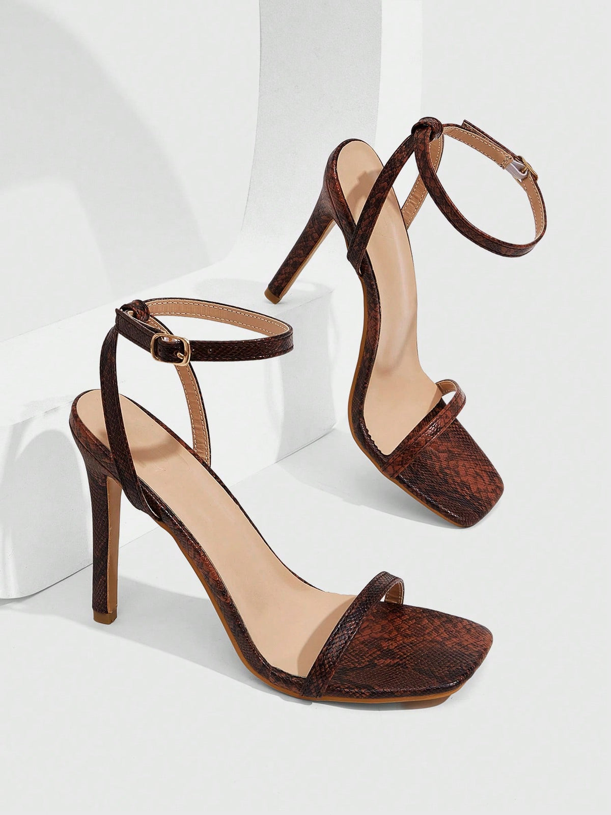 Elegant women's open toe strappy heeled sandals with stiletto high heel and ankle strap buckle closure.