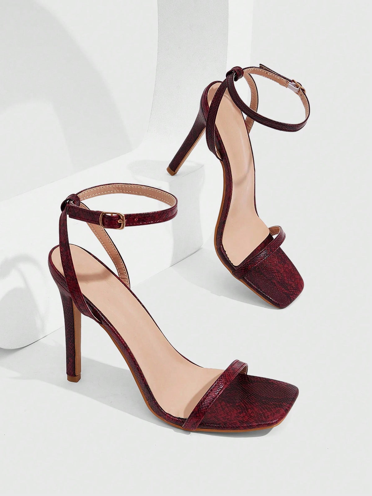 Elegant women's open toe strappy heeled sandals with stiletto high heel and ankle strap buckle closure.