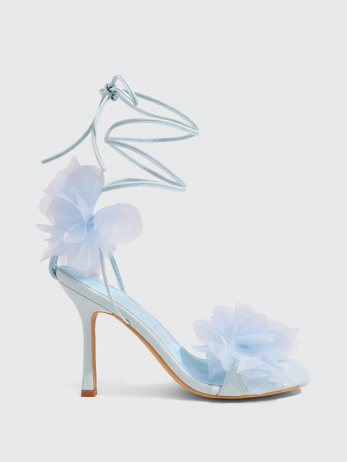 Women's open toe heeled sandals featuring 3D floral decor, satin lace-up ankle straps, and stiletto high heels.