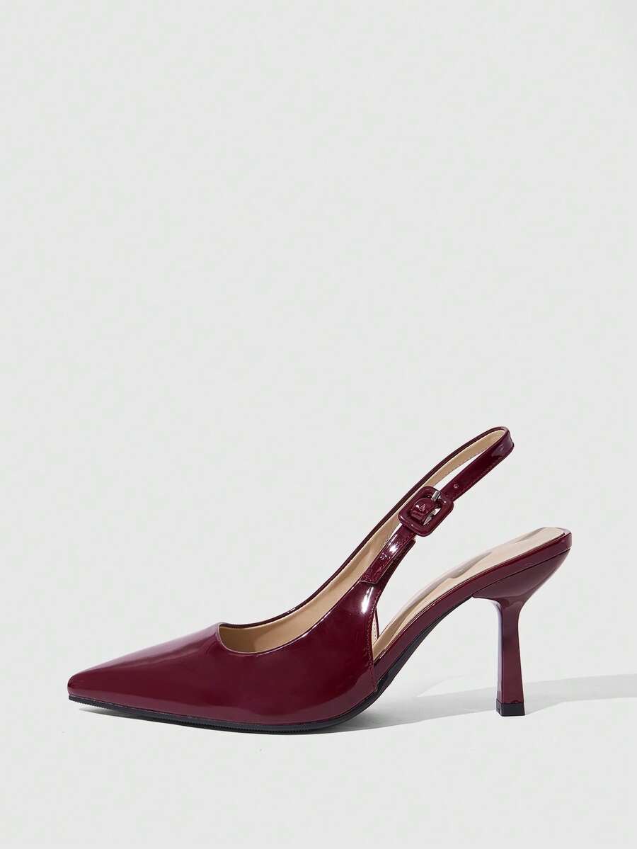 Women's pointed-toe high heel pumps in black mirror PU leather with an ankle strap, stiletto heel, and rhinestone buckle.