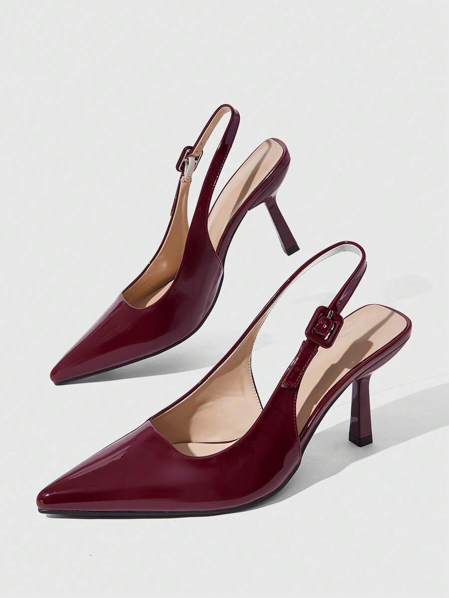 Women's pointed-toe high heel pumps in black mirror PU leather with an ankle strap, stiletto heel, and rhinestone buckle.