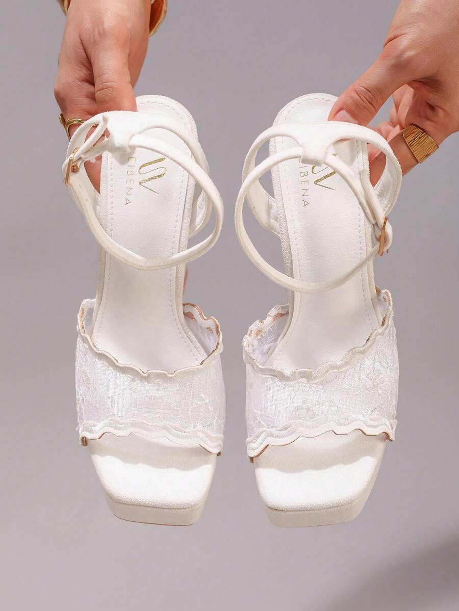 Lace embroidered open toe high heel sandals featuring a chunky square heel, platform wedge, and ankle strap buckle closure.