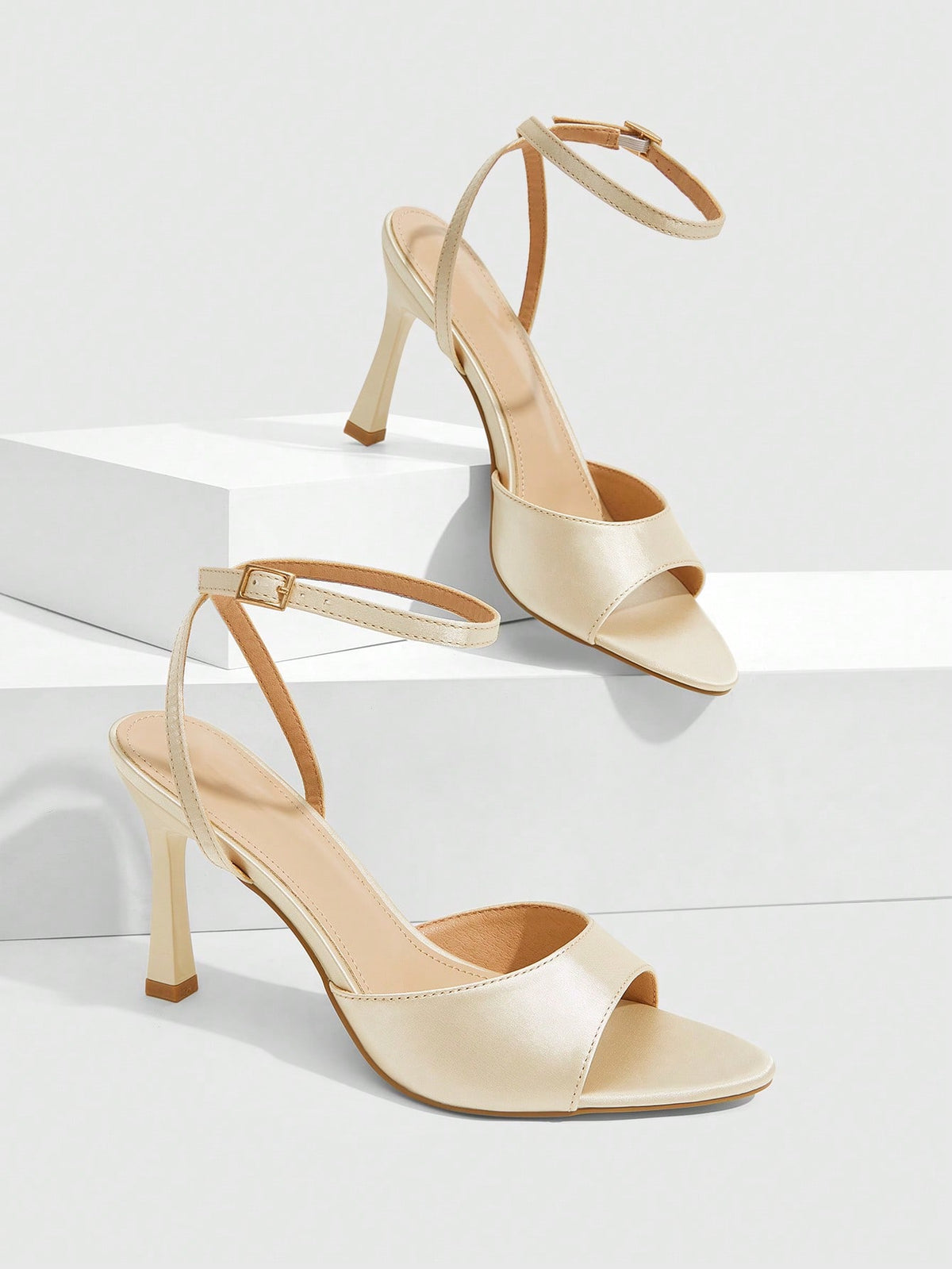 Women's pointed peep toe high heel stilettos featuring cross ankle strap with buckle in black PU leather.