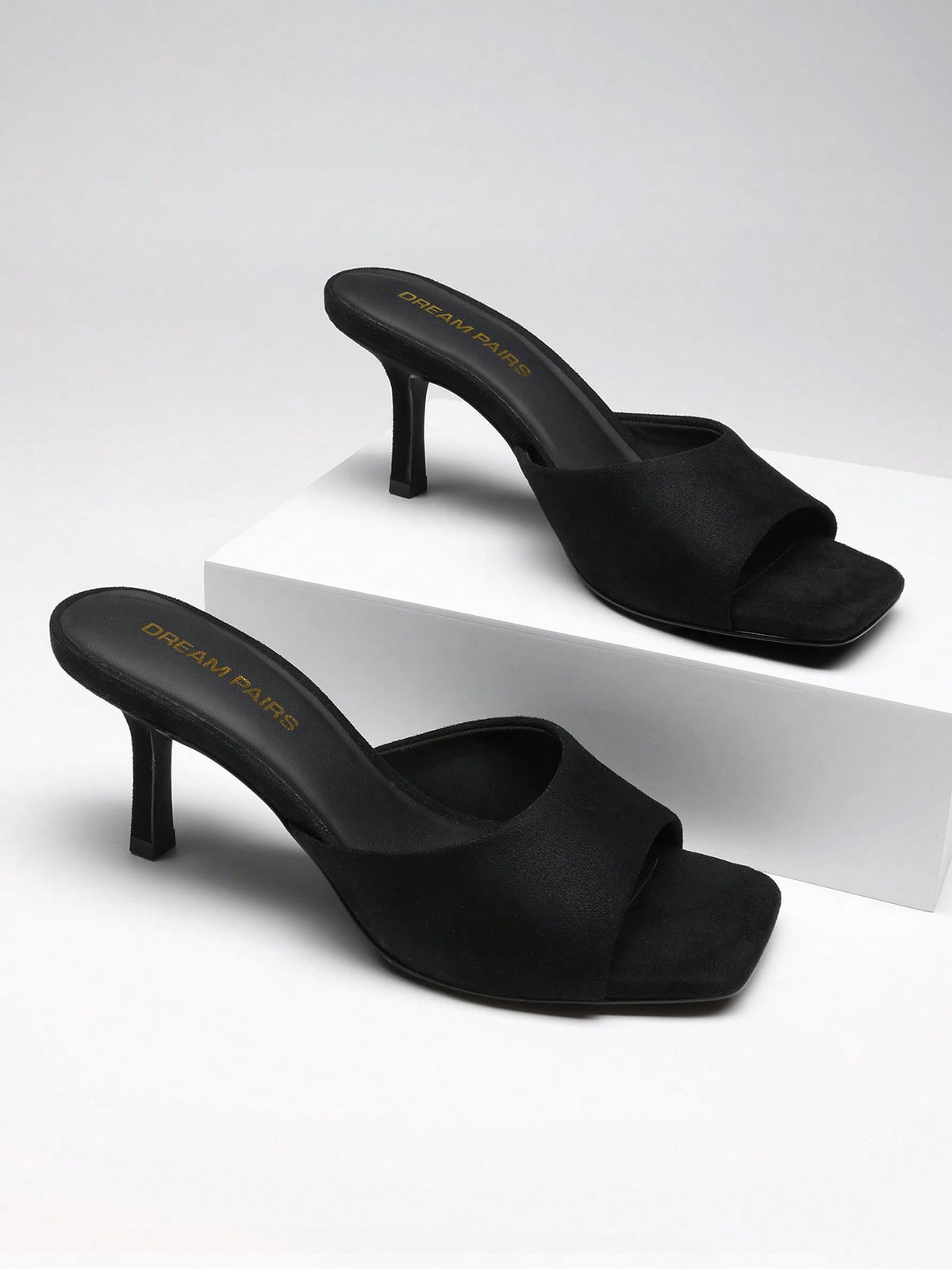 Pair of women's open square toe kitten heel mule sandals in white PU leather with slip-on styling.