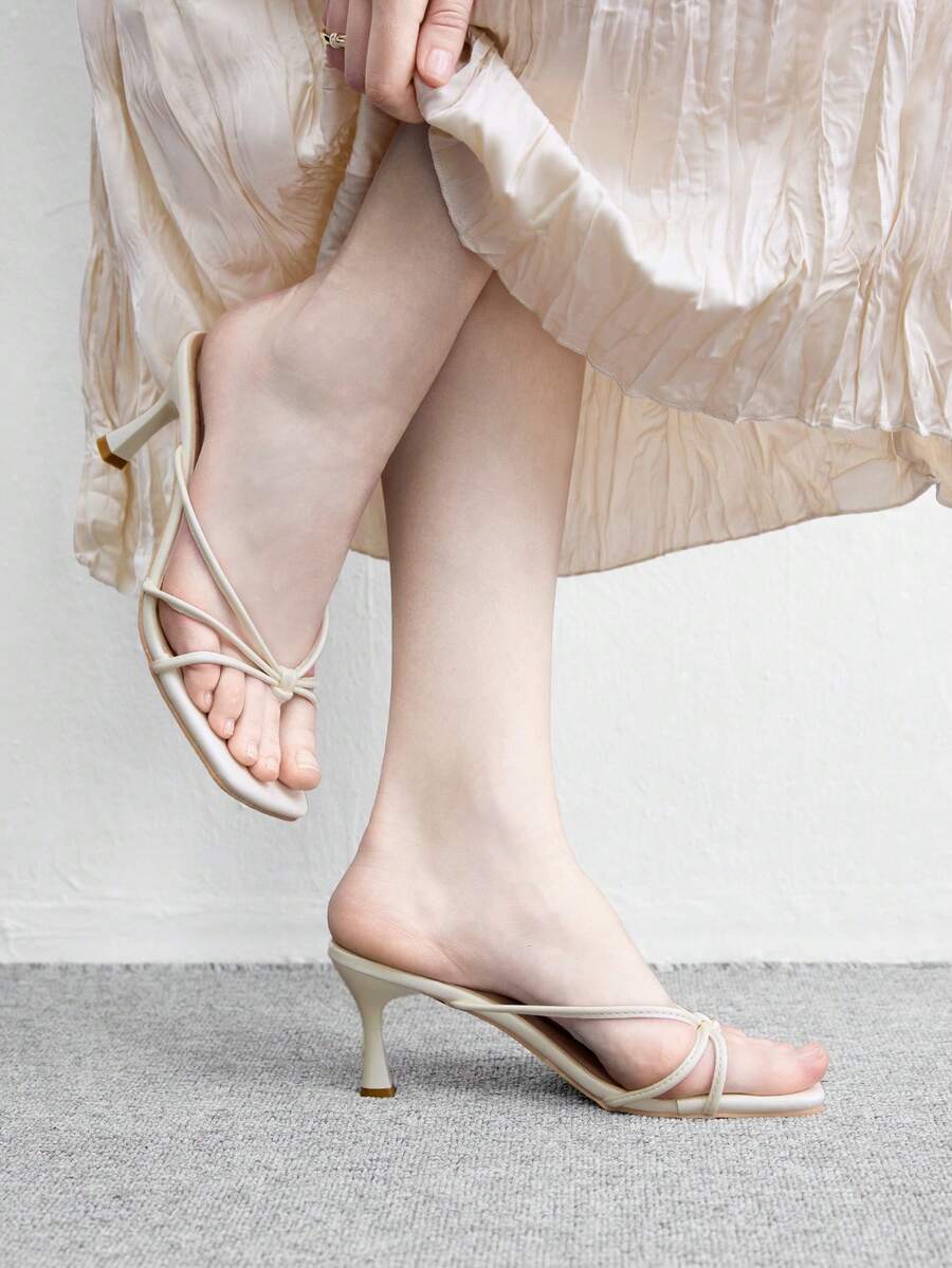 Square toe stiletto heel thong sandals for women featuring thin toe post strap, knot detail, and mid pyramid heel.