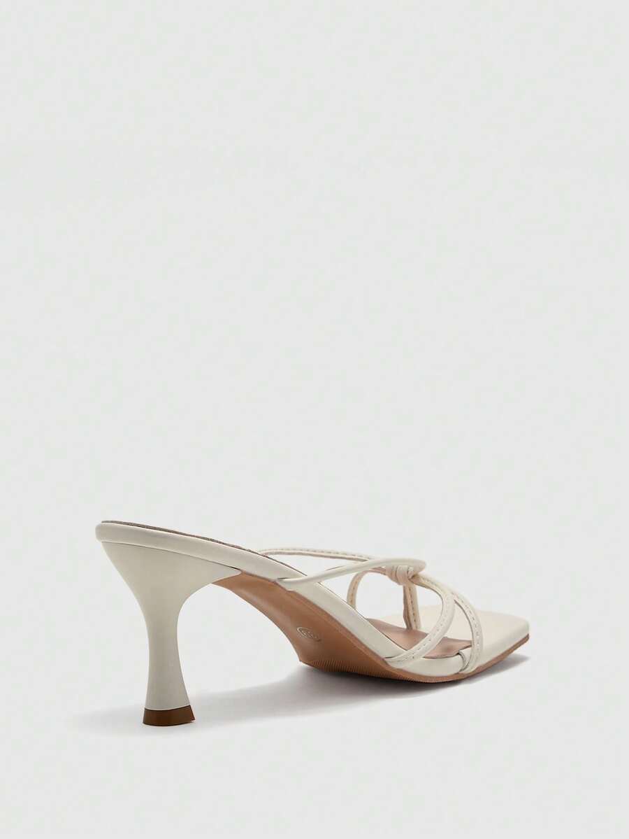 Square toe stiletto heel thong sandals for women featuring thin toe post strap, knot detail, and mid pyramid heel.