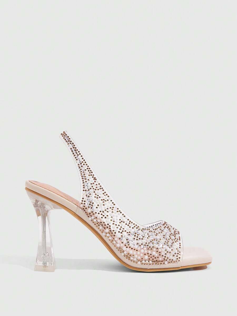 Women's square toe heeled sandals with clear straps, sparkling rhinestone embellishments, and a high pyramid heel.