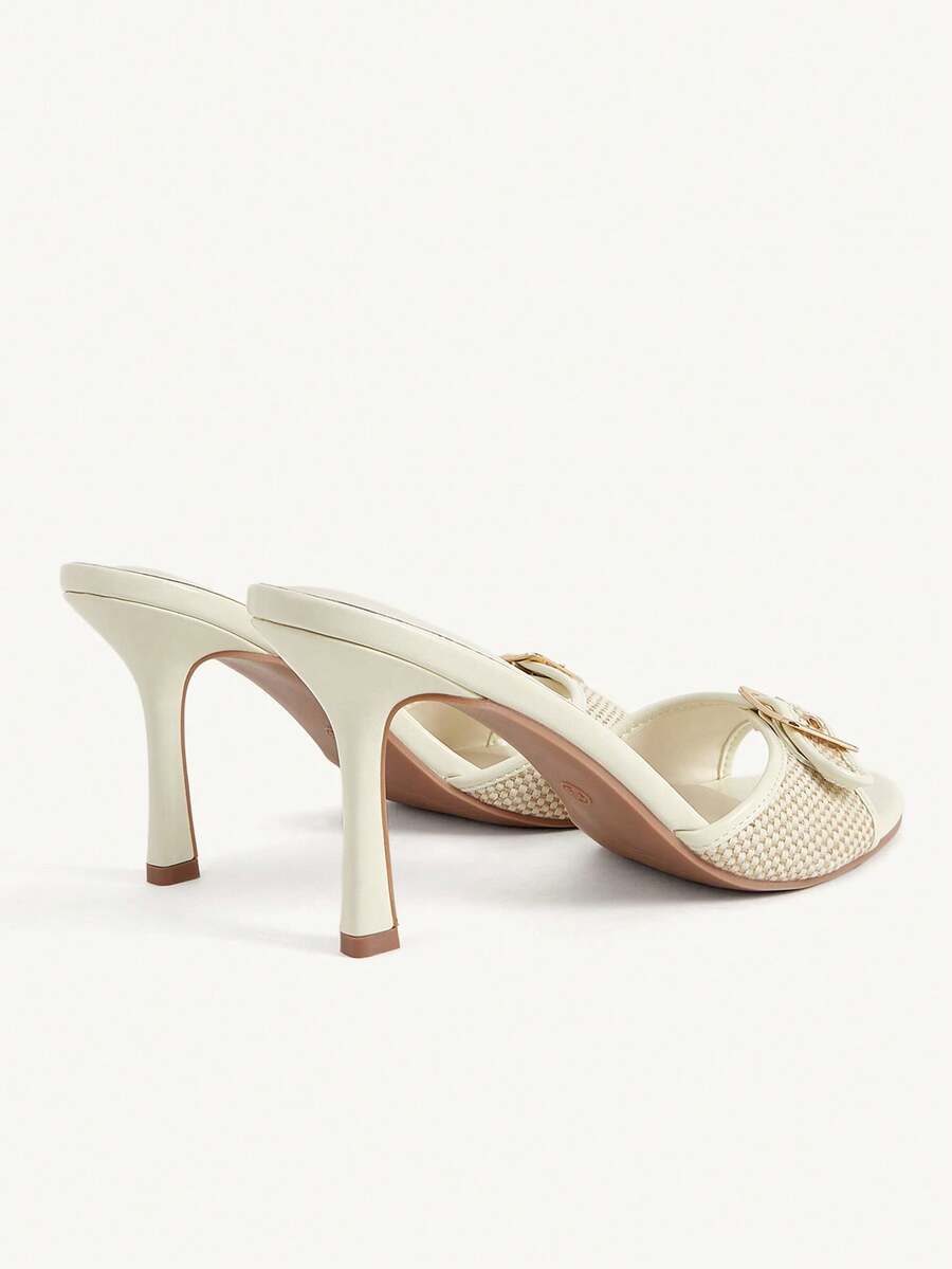 Women's brown leopard print high heel mule sandals with gold-tone buckle and grommet eyelet accents.