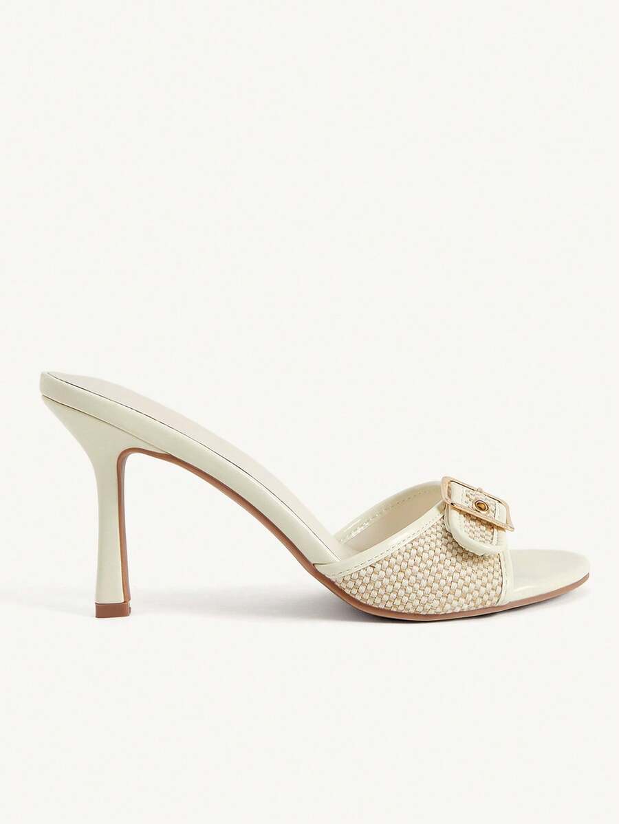 Women's brown leopard print high heel mule sandals with gold-tone buckle and grommet eyelet accents.
