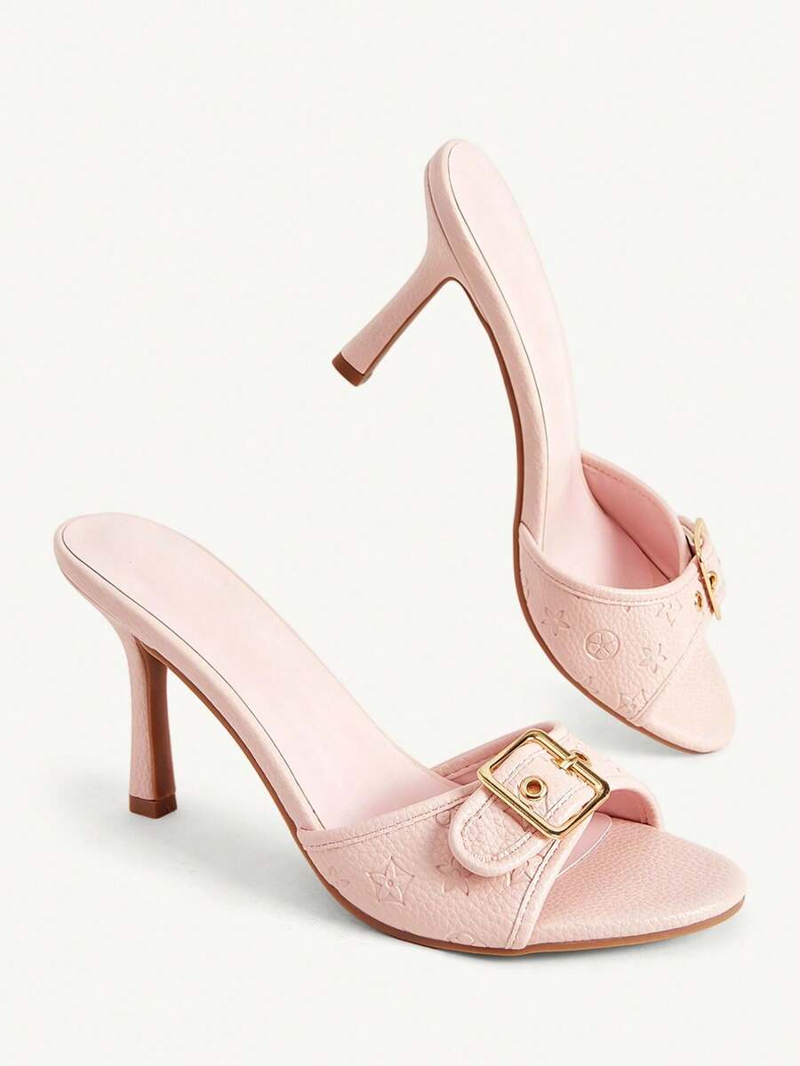Women's brown leopard print high heel mule sandals with gold-tone buckle and grommet eyelet accents.