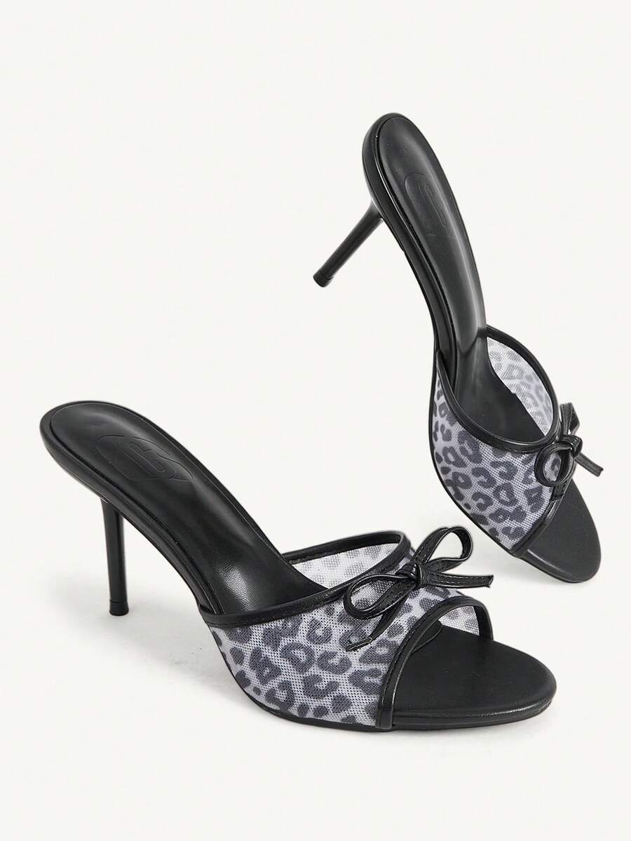 Women's open-toe leopard print mesh stiletto heeled sandals with bow detail.