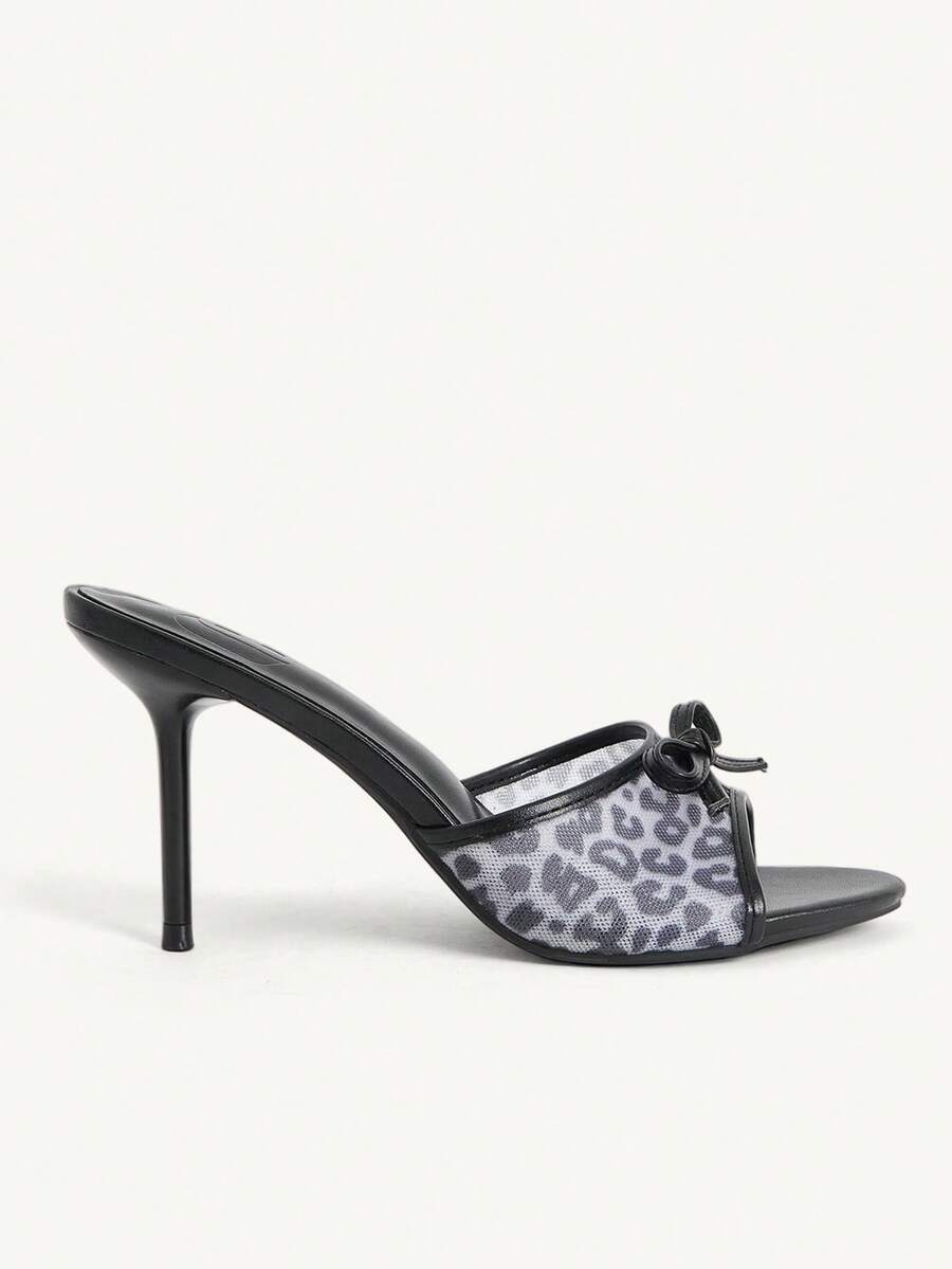 Women's open-toe leopard print mesh stiletto heeled sandals with bow detail.