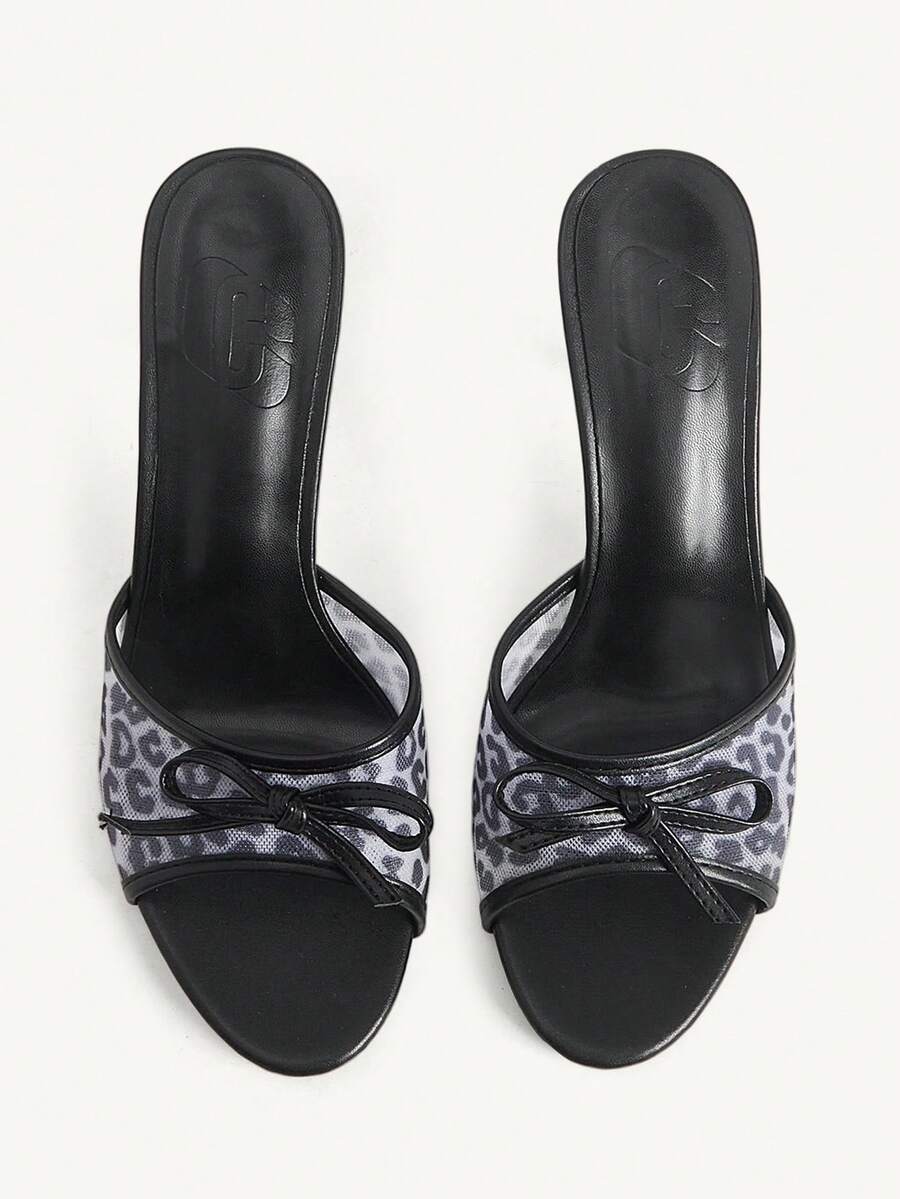 Women's open-toe leopard print mesh stiletto heeled sandals with bow detail.