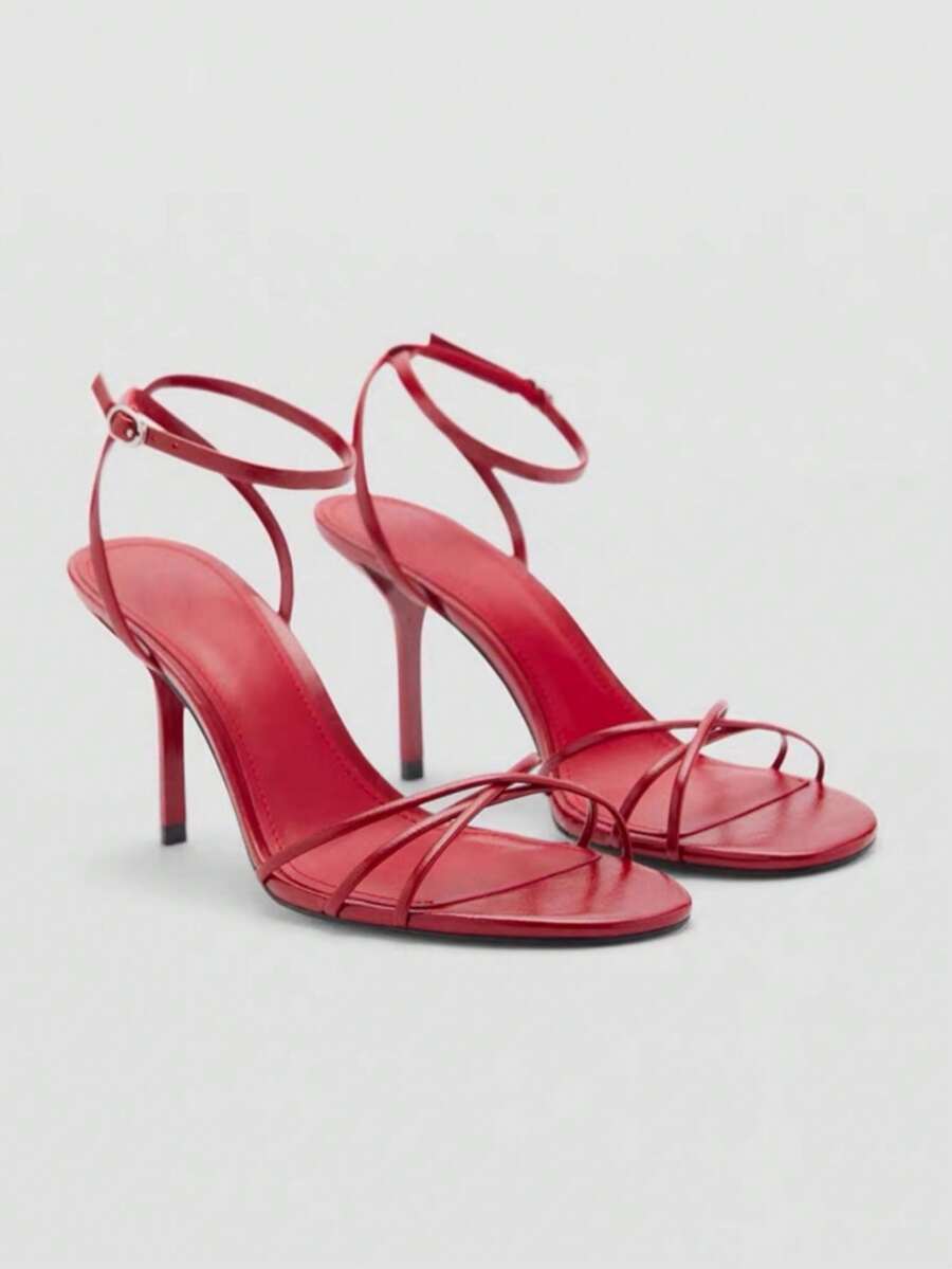 Women's open toe stiletto high heel sandals featuring metallic knot decor and an adjustable ankle buckle strap.