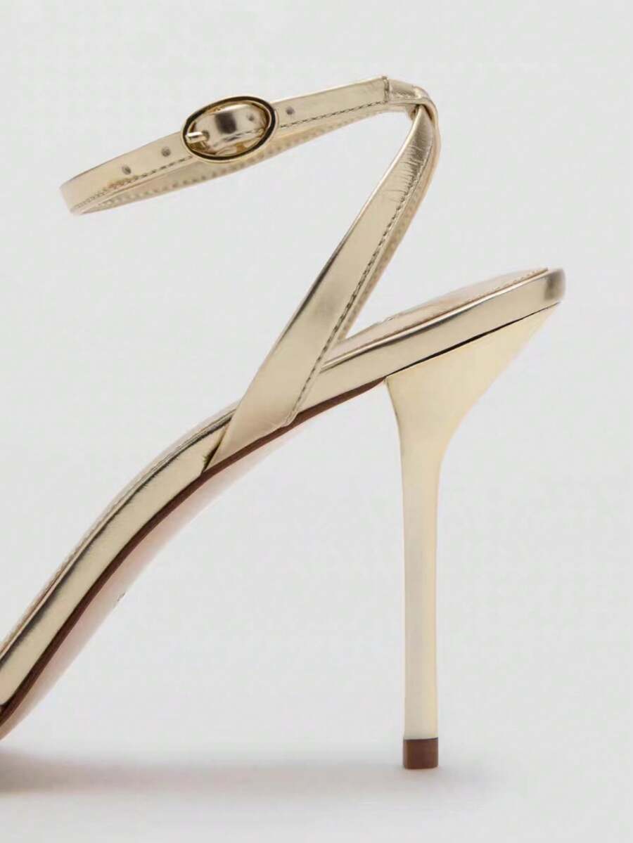 Women's open toe stiletto high heel sandals featuring metallic knot decor and an adjustable ankle buckle strap.