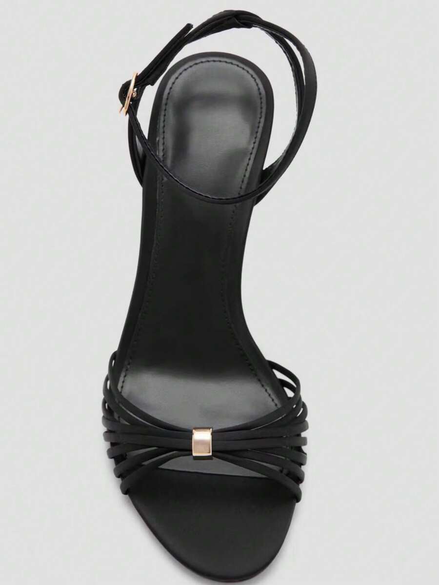 Women's open toe stiletto high heel sandals featuring metallic knot decor and an adjustable ankle buckle strap.