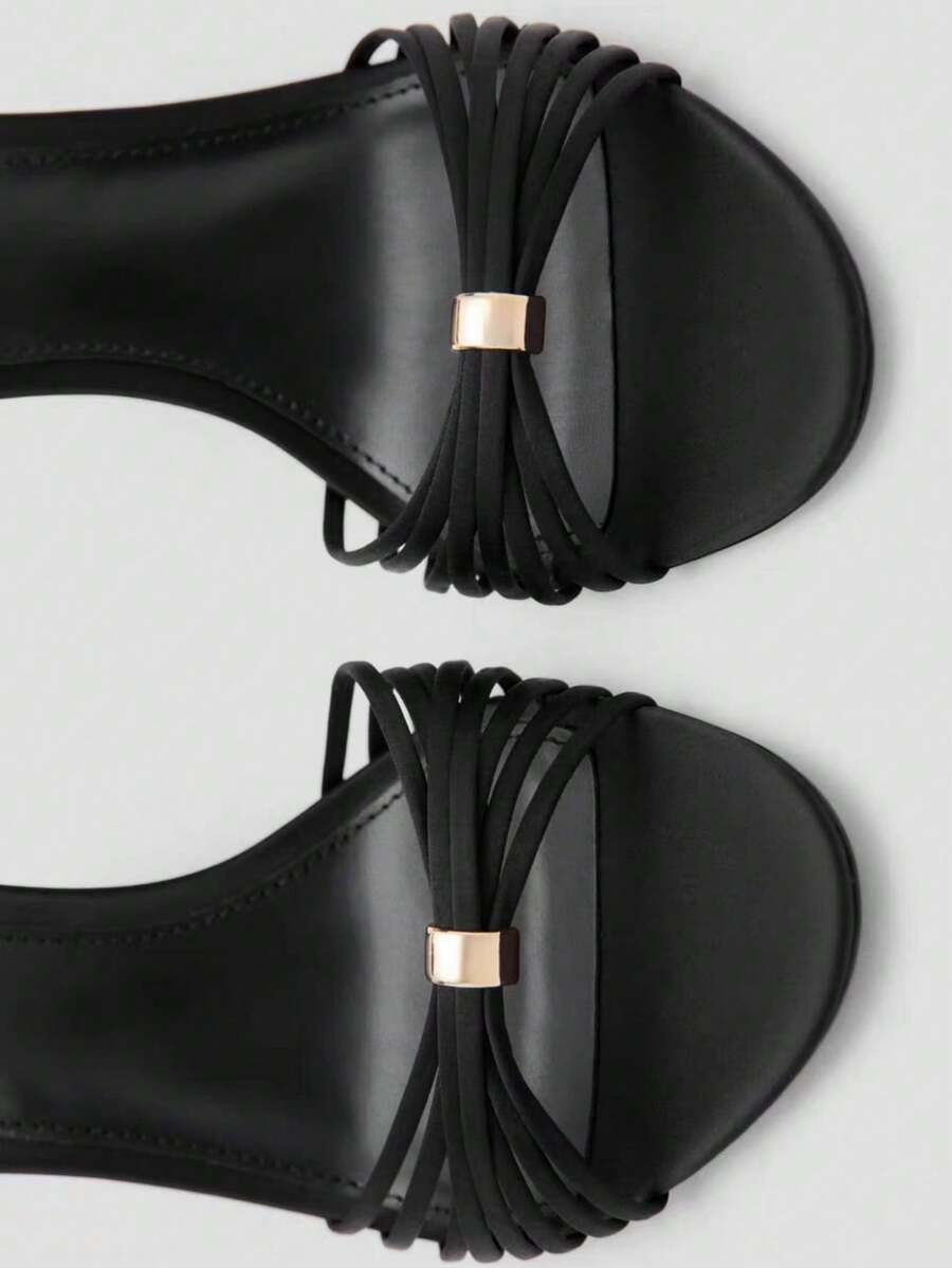 Women's open toe stiletto high heel sandals featuring metallic knot decor and an adjustable ankle buckle strap.
