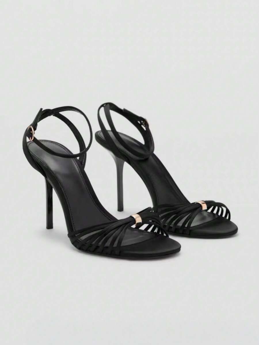 Women's open toe stiletto high heel sandals featuring metallic knot decor and an adjustable ankle buckle strap.