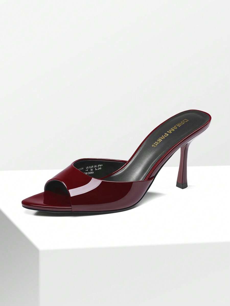 Women's pointed peep toe high heel sandals featuring a sleek stiletto heel, slip-on mule design, and smooth faux leather finish.