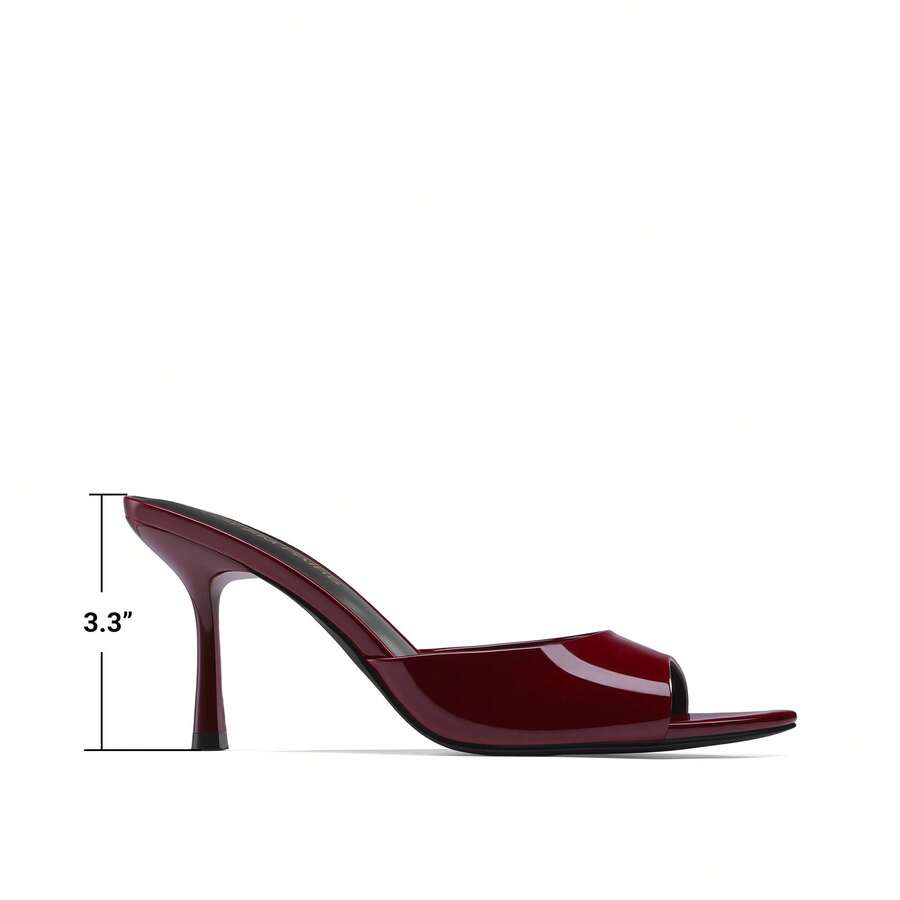 Women's pointed peep toe high heel sandals featuring a sleek stiletto heel, slip-on mule design, and smooth faux leather finish.