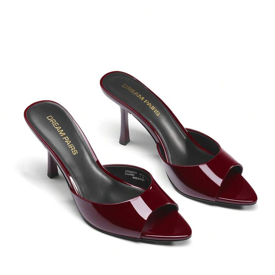 Women's pointed peep toe high heel sandals featuring a sleek stiletto heel, slip-on mule design, and smooth faux leather finish.