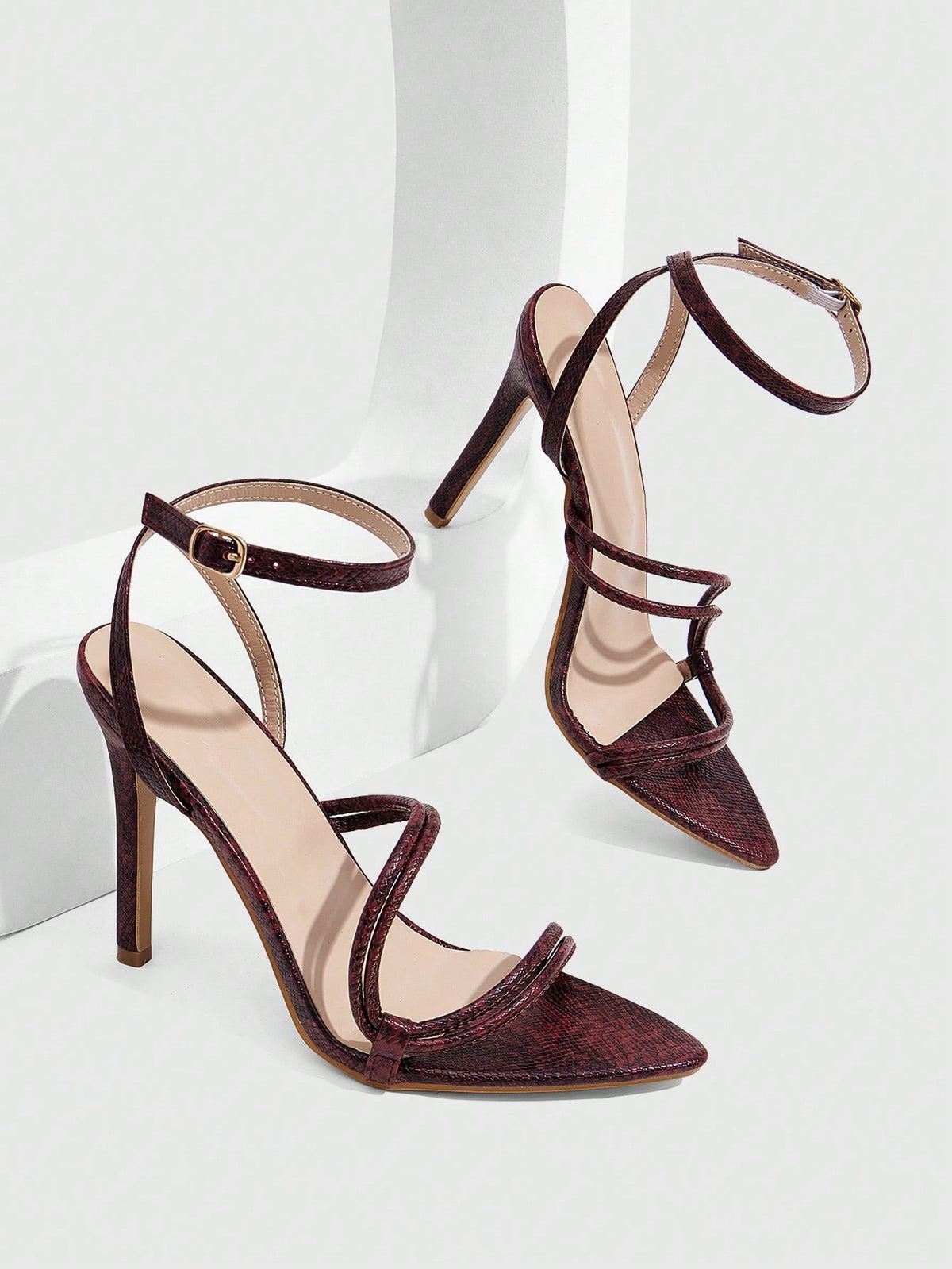 Snake pattern open toe high heel sandals with thin stiletto heel and buckle ankle strap for women.