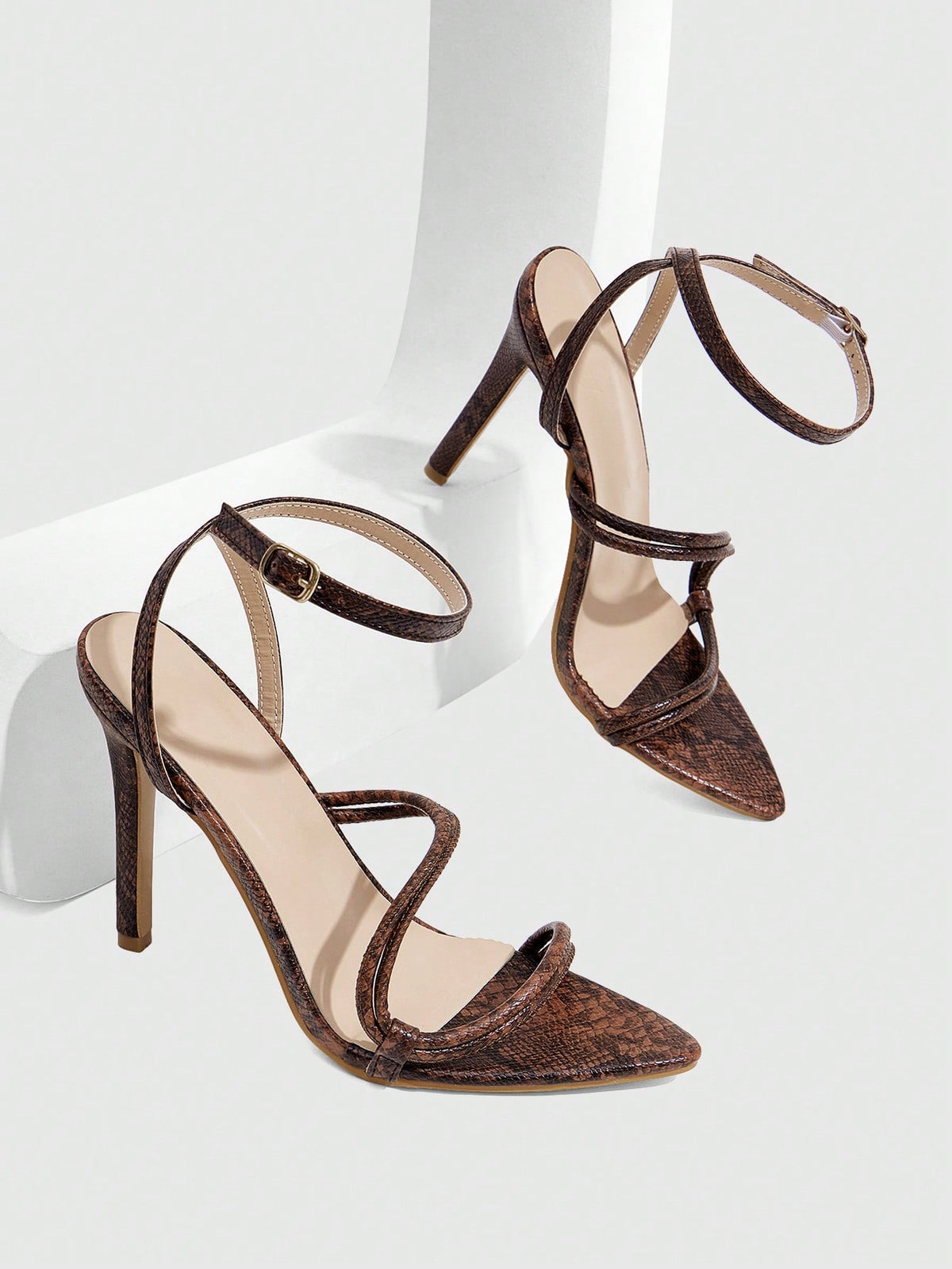 Snake pattern open toe high heel sandals with thin stiletto heel and buckle ankle strap for women.