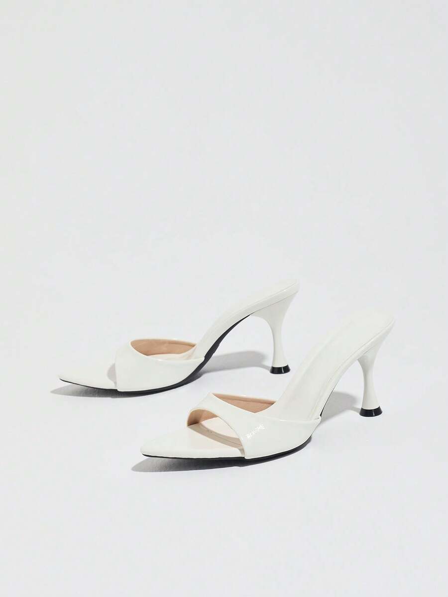 Women's open pointed toe stiletto mule high heel sandals featuring a glossy slip-on design.