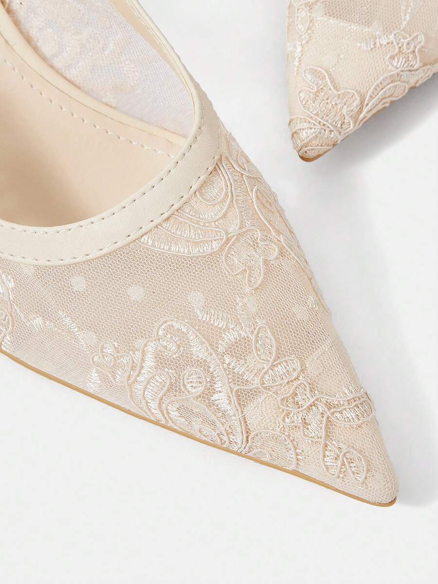 Pointed toe stiletto high heel pumps featuring black lace mesh upper, buckle slingback detail, and sleek slip-on design for weddings and evening wear.