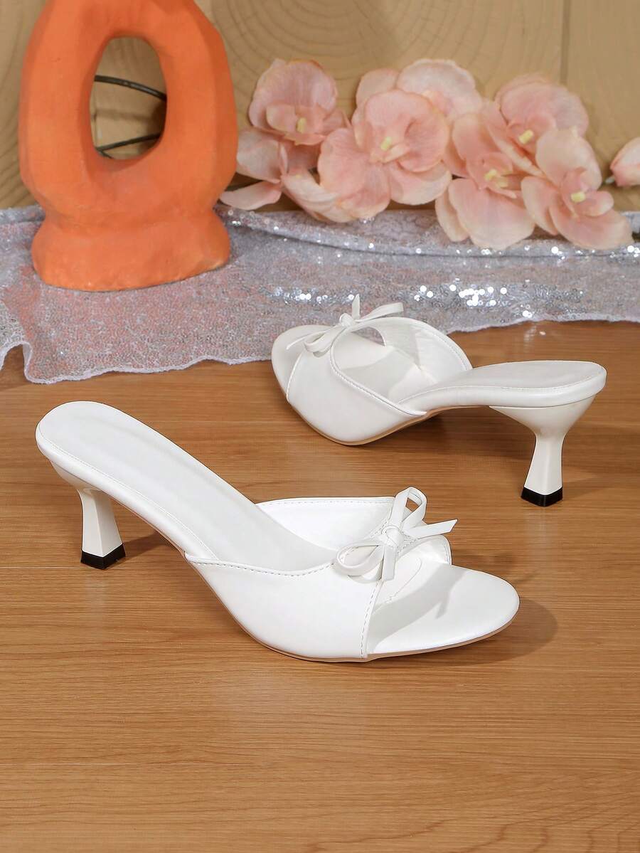 Women's open toe stiletto sandals in PU leather featuring slip-on slingback straps and bow accents for summer parties
