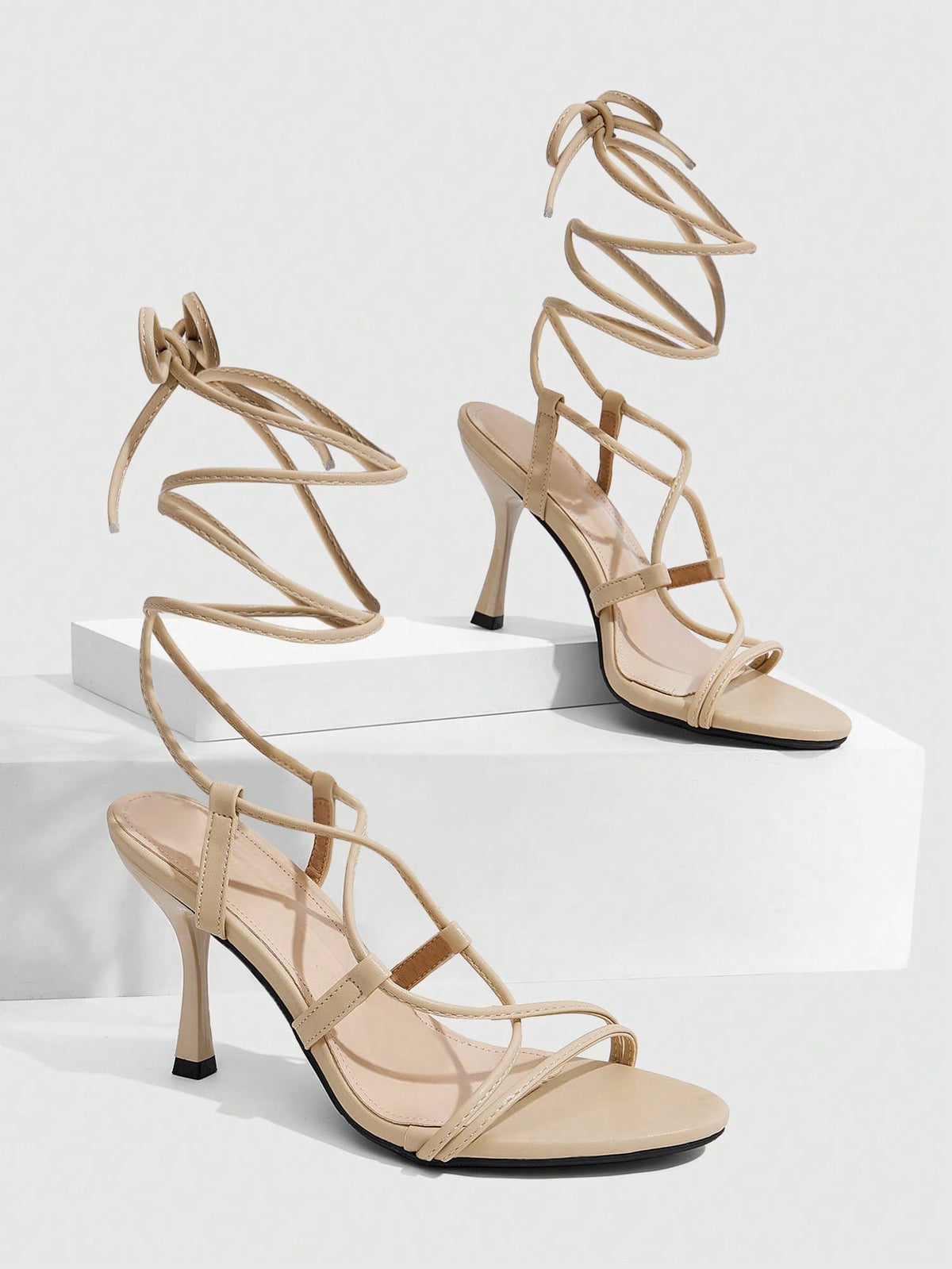 Women's open toe stiletto high heel sandals with criss cross straps and sleek PU leather finish