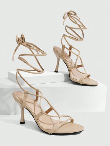 Women's open toe stiletto high heel sandals with criss cross straps and sleek PU leather finish