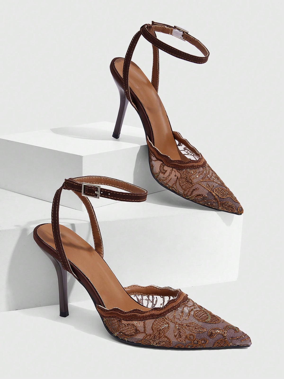 Women's stiletto high heel shoes featuring an elegant buckle detail and ankle strap slingback design.