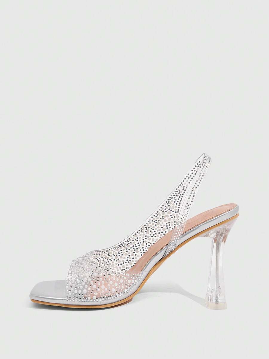 Women's square toe heeled sandals with clear straps, sparkling rhinestone embellishments, and a high pyramid heel.