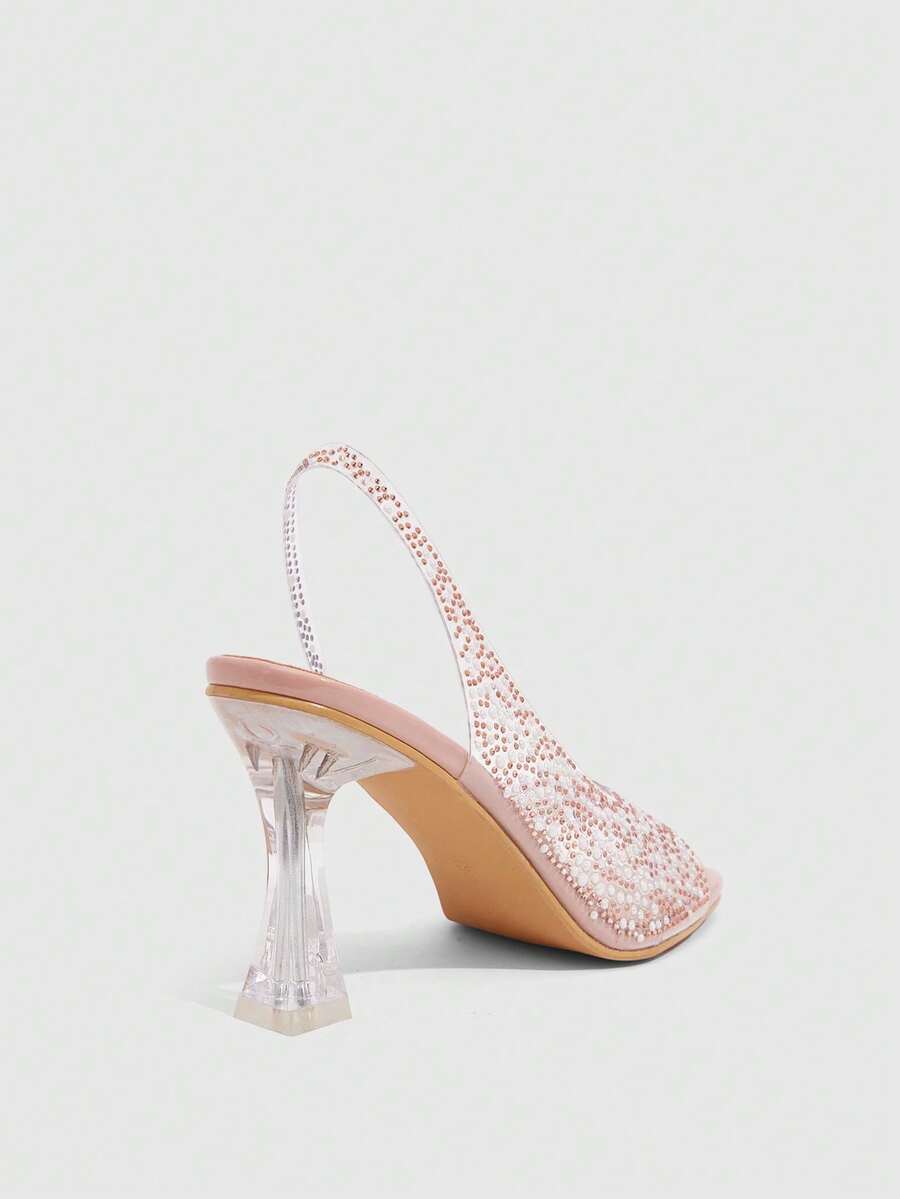 Women's square toe heeled sandals with clear straps, sparkling rhinestone embellishments, and a high pyramid heel.