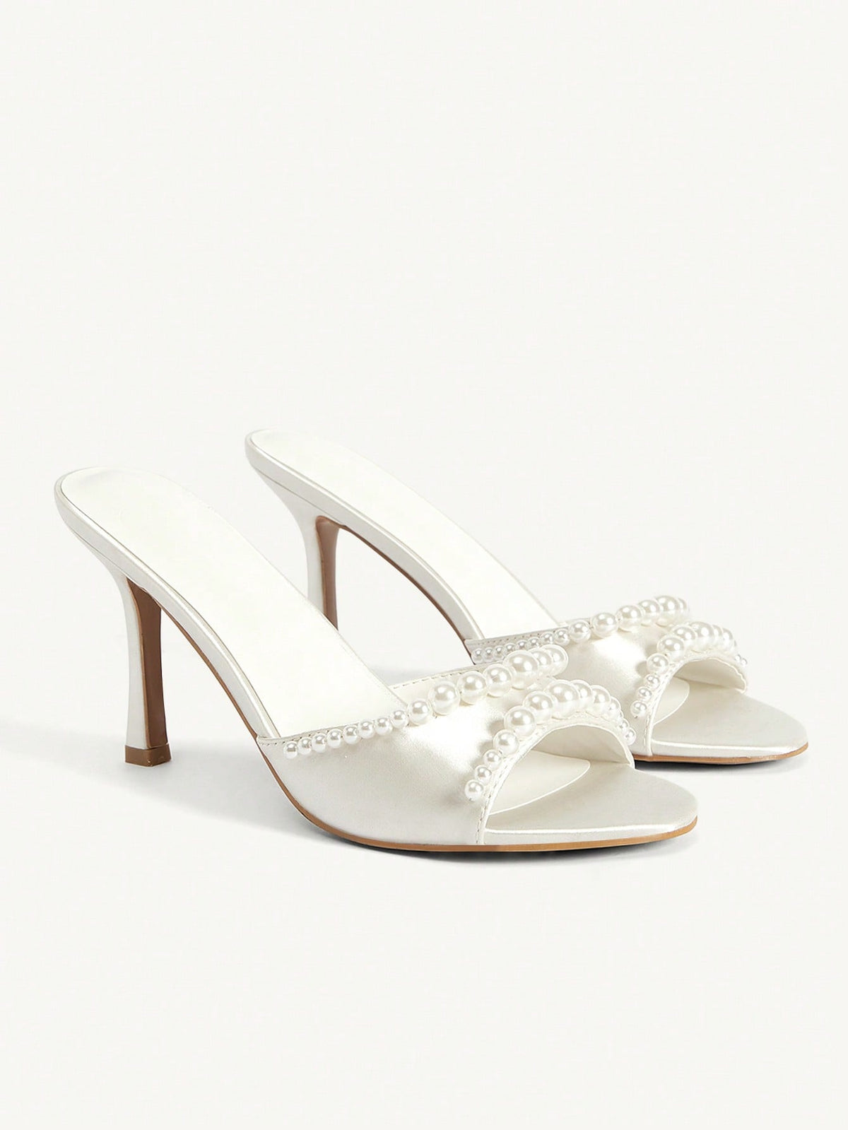 Elegant women's satin high heel sandals with pearl embellishments, stiletto heels, and slingback straps for bridal and wedding wear.