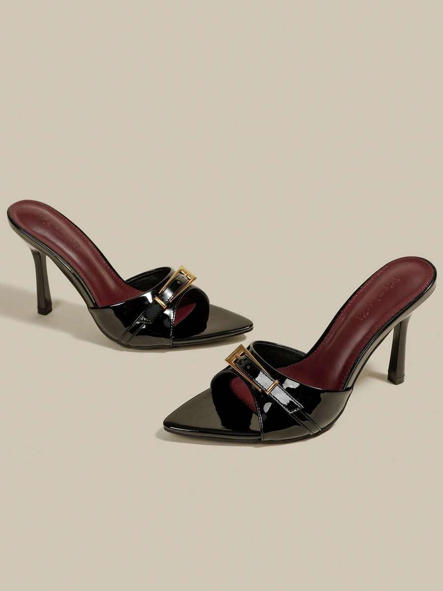 Black patent leather pointed toe mule sandals featuring stiletto high heels and decorative buckle detail for evening parties