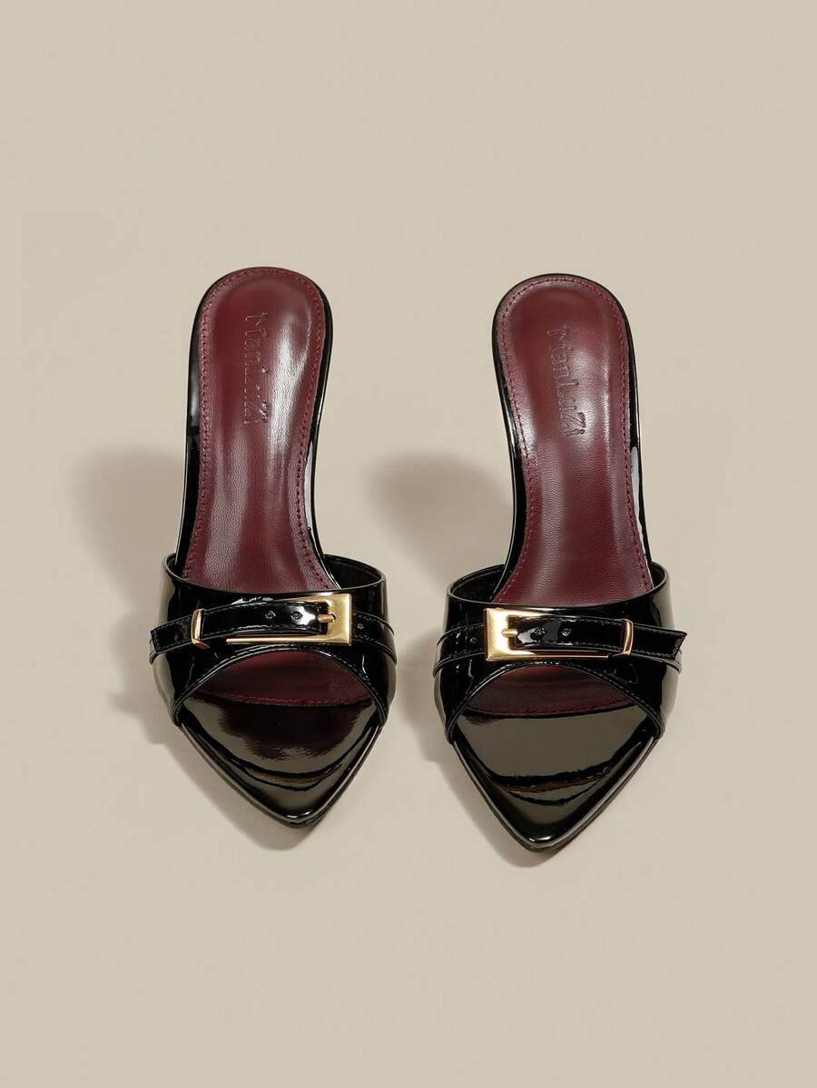 Black patent leather pointed toe mule sandals featuring stiletto high heels and decorative buckle detail for evening parties