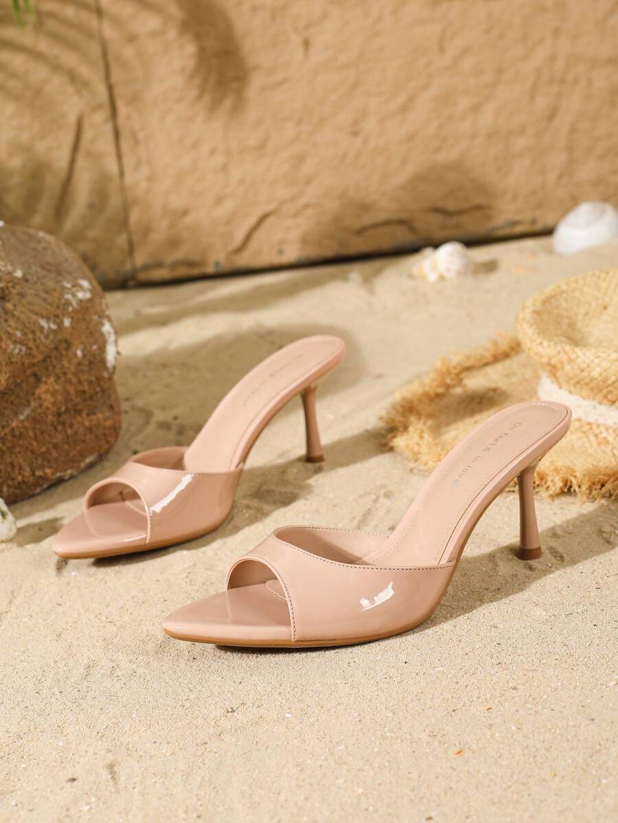 Women's open toe slide sandals featuring sleek patent leather and thin stiletto heels