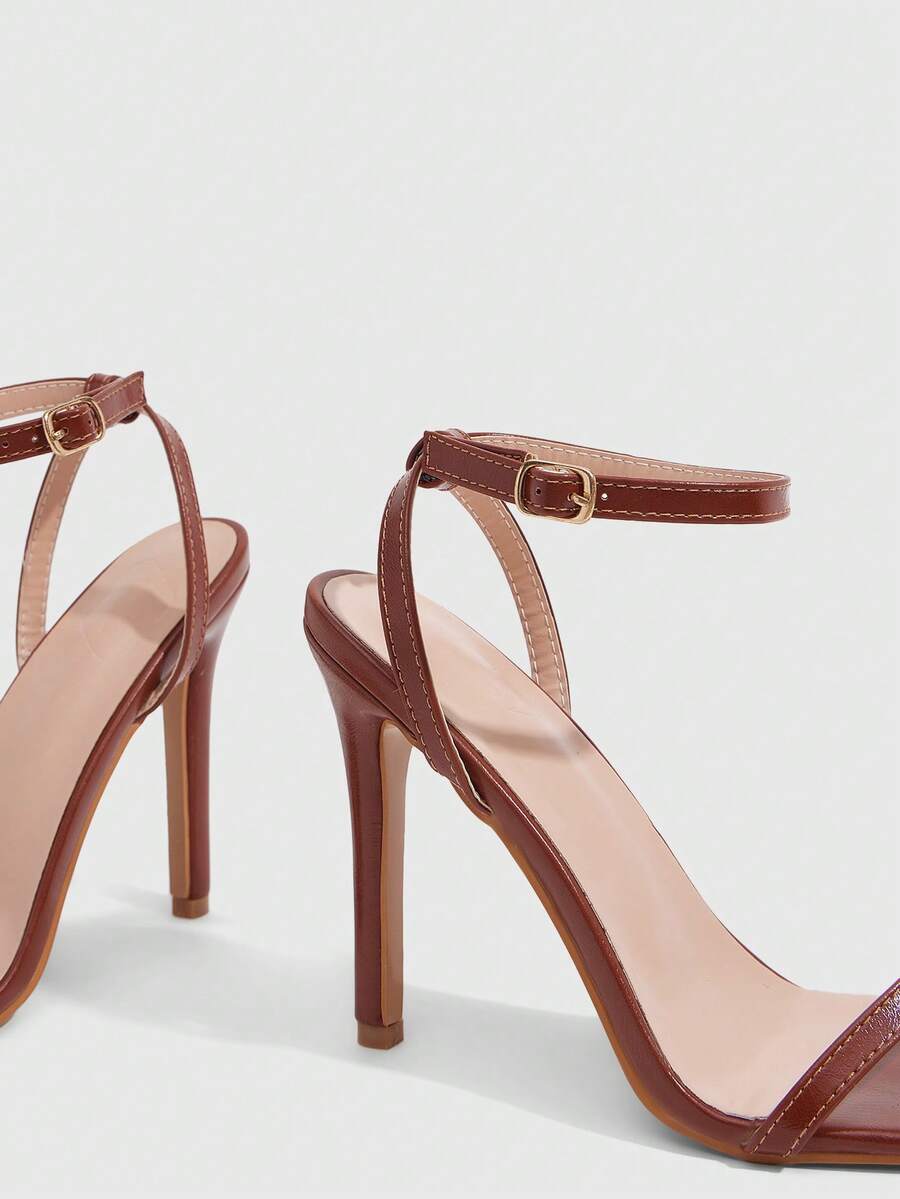 Elegant women's open toe strappy heeled sandals with stiletto high heel and ankle strap buckle closure.