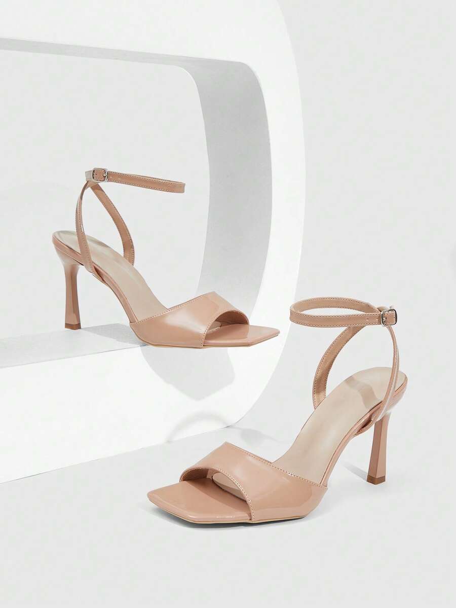 Women's peep toe ankle strap high heel sandals featuring a sleek stiletto heel and adjustable buckle closure.