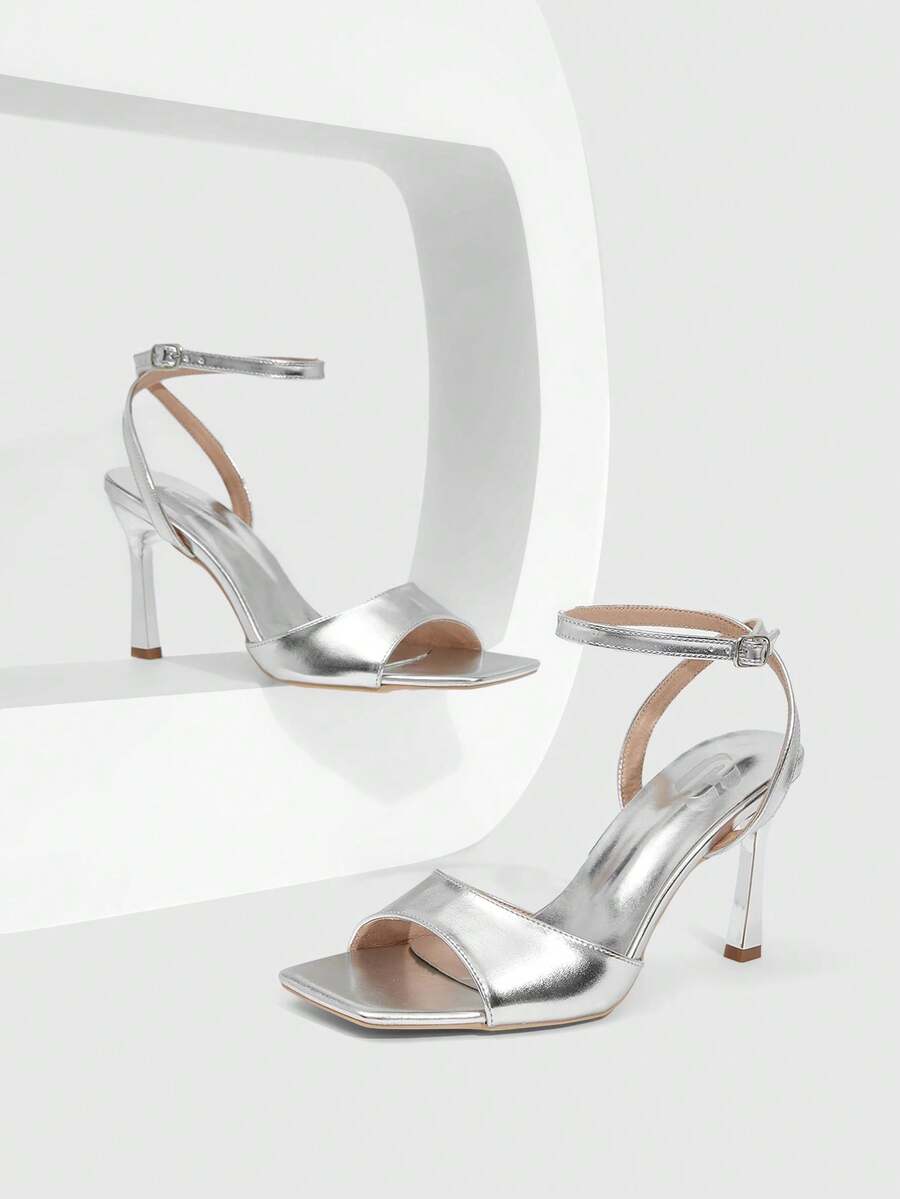 Women's peep toe ankle strap high heel sandals featuring a sleek stiletto heel and adjustable buckle closure.