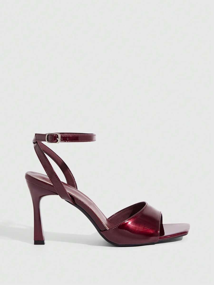 Women's peep toe ankle strap high heel sandals featuring a sleek stiletto heel and adjustable buckle closure.